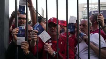 Liverpool fans show their tickets as they are locked out of May’s Champions League final