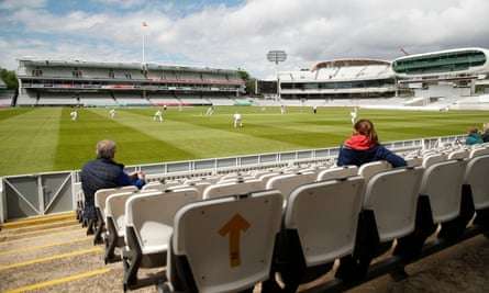 A handful of fans watch the Eton v Harrow match to the backdrop of an empty ground