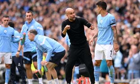 The Manchester City manager, Pep Guardiola, gives instructions to João Cancelo during the Premier League match against Manchester United at Etihad Stadium on 2 October, 2022.