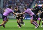 New Zealand full-back Beauden Barrett tries to break Scotland’s line